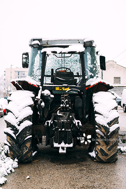 冬季公园背景下的雪地拖拉机后轮特写图片素材