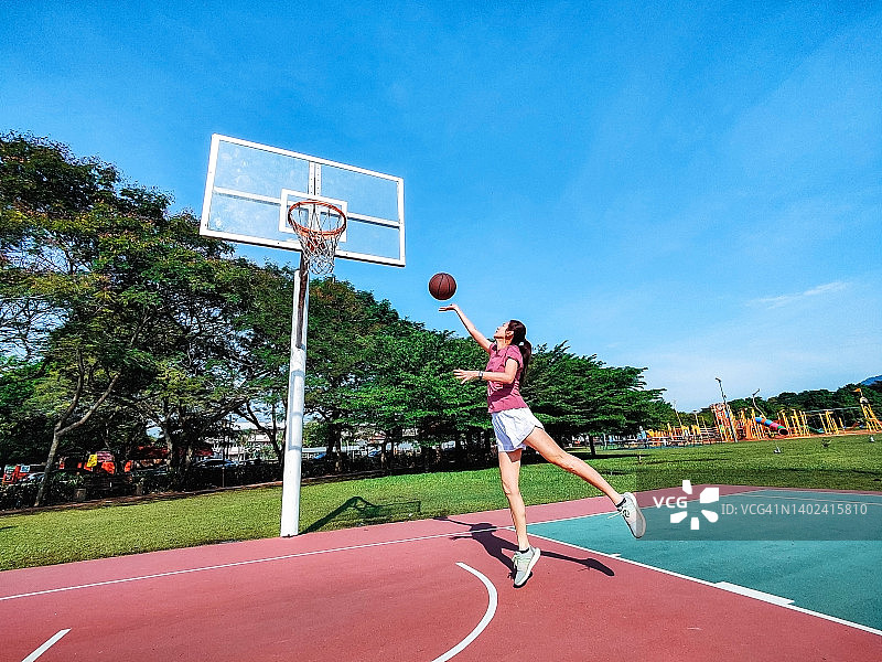 年轻运动员在球场上打篮球图片素材
