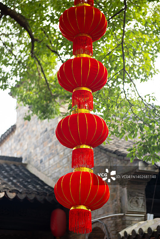 中国新年期间传统公园里悬挂的书籍上的红色灯笼图片素材