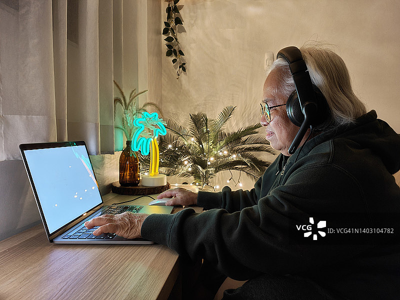 亚洲老年妇女学习玩电子游戏图片素材