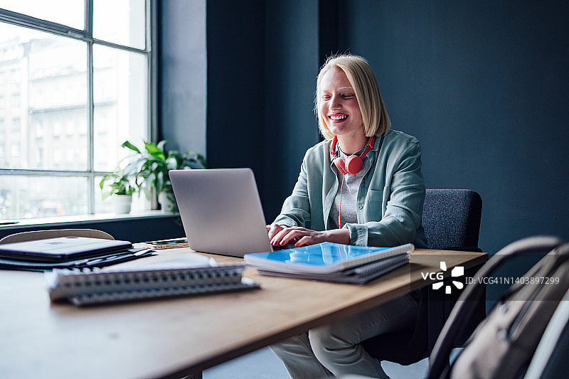 快乐的学生在图书馆用笔记本电脑在线学习图片素材