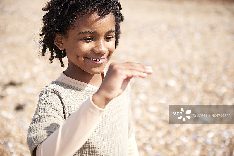 在海滩上享受家庭日的7岁男孩图片素材
