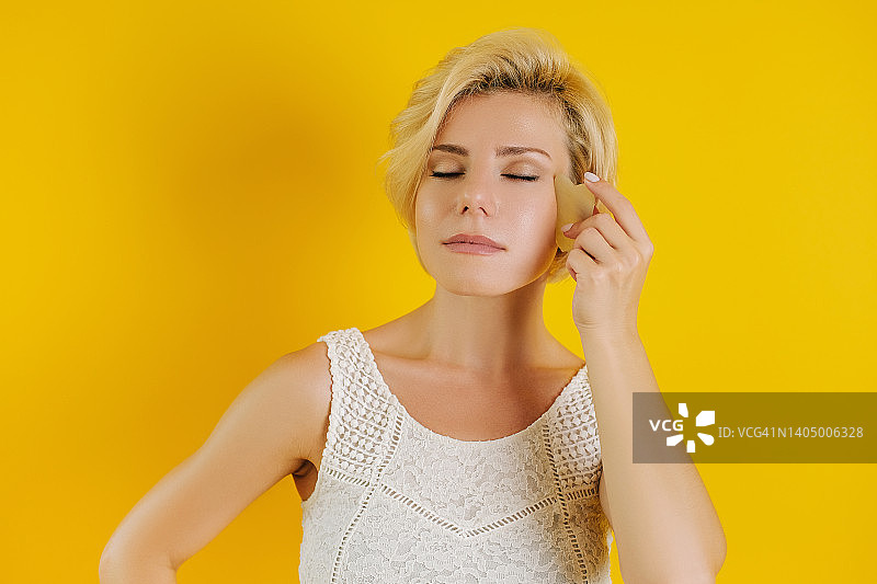 使用刮痧板的年轻女人图片素材