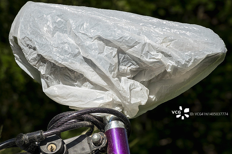 用塑料袋防雨罩盖住的自行车鞍座图片素材