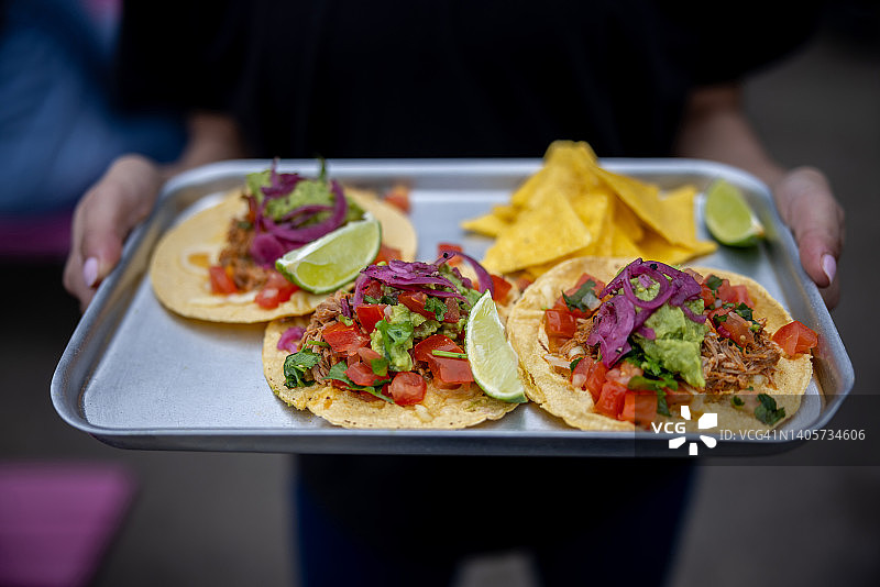 墨西哥餐厅女服务员端着墨西哥卷饼的特写图片素材