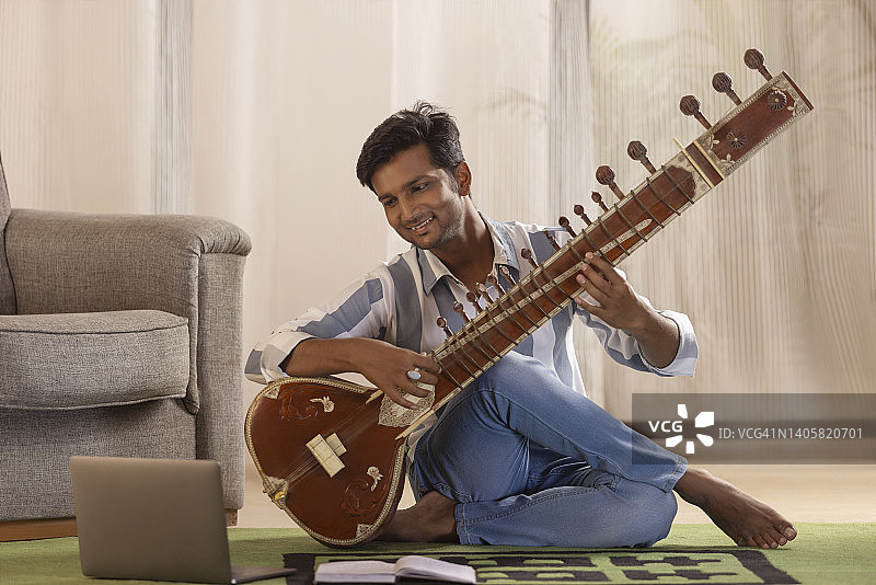 上在线西塔琴课的年轻男人肖像图片素材