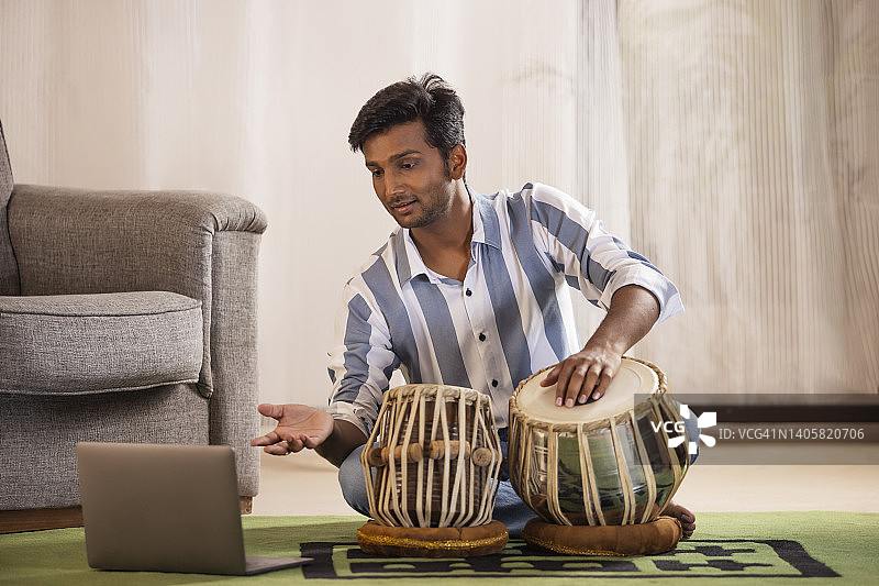 年轻男子上在线塔布拉鼓课程的肖像图片素材