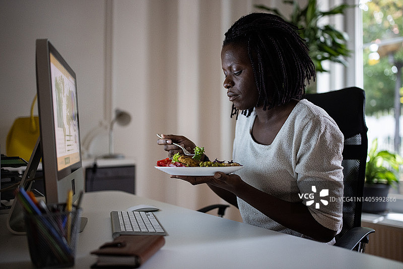 在办公室吃健康餐的黑人女性图片素材