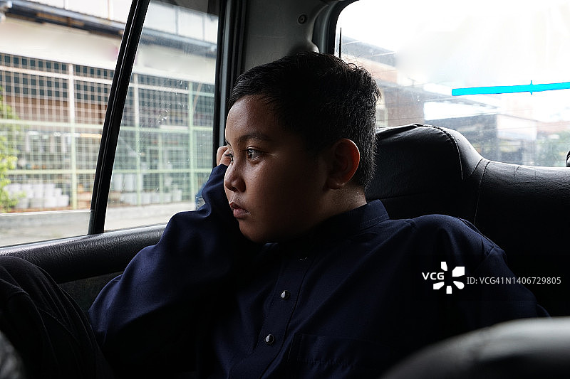 亚洲男孩看着车窗外图片素材