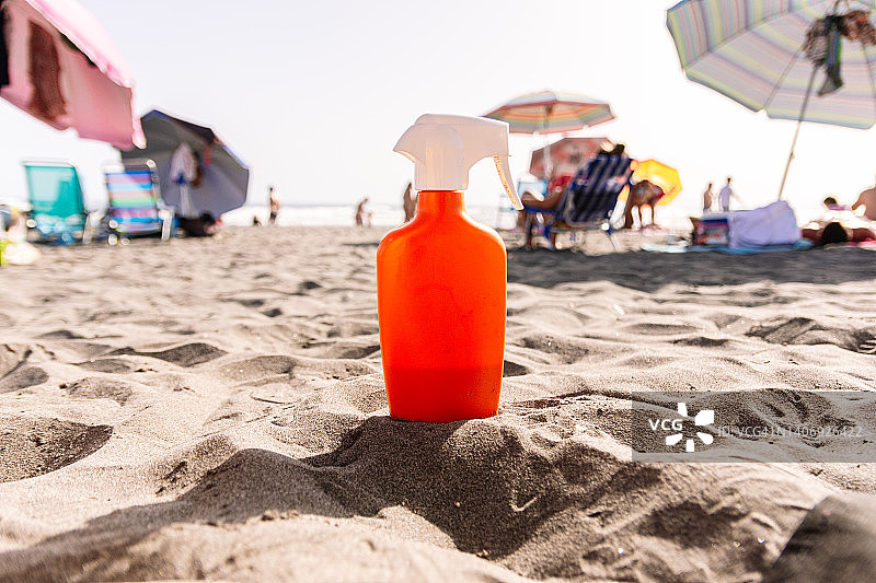 沙滩上橙色的防晒霜，夏季图片素材