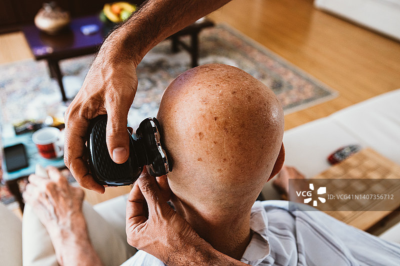 儿子在家为老年男子理发图片素材