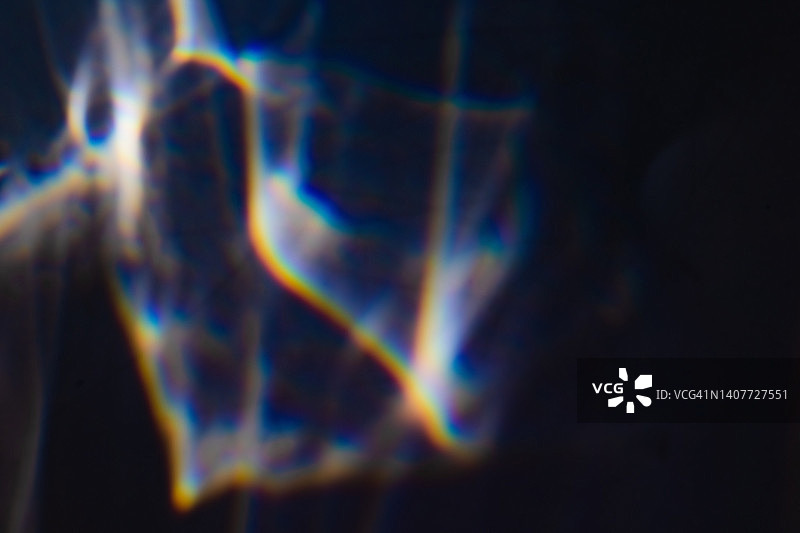 黑色背景上的彩色彩虹漏光纹理图片素材