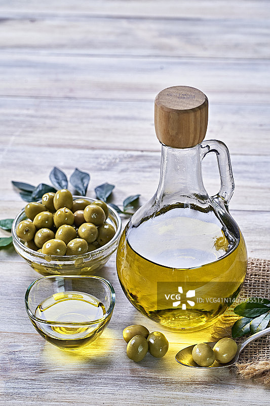 橄榄油瓶和橄榄特写：摆放在老式乡村厨房的桌子上，留有文案空间图片素材