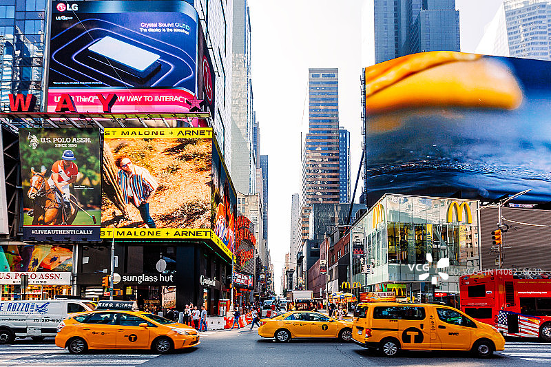 阳光下的纽约时代广场：商业广告与繁忙交通图片素材