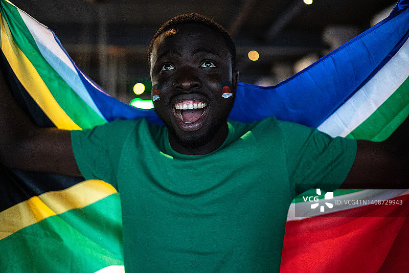 年轻男人手持南非国旗庆祝图片素材