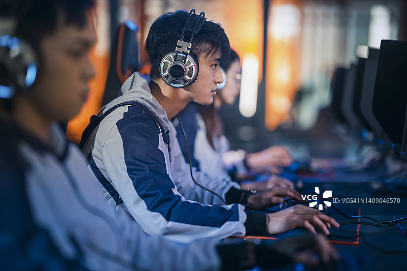 电竞总决赛：亚裔电竞选手专注玩RPG第一人称射击游戏图片素材