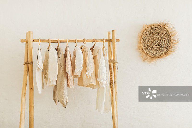 木质衣柜中衣架上整齐悬挂的衣服图片素材