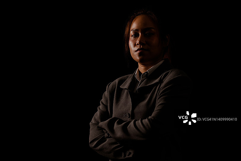 高对比度深色背景下的年轻女子肖像图片素材