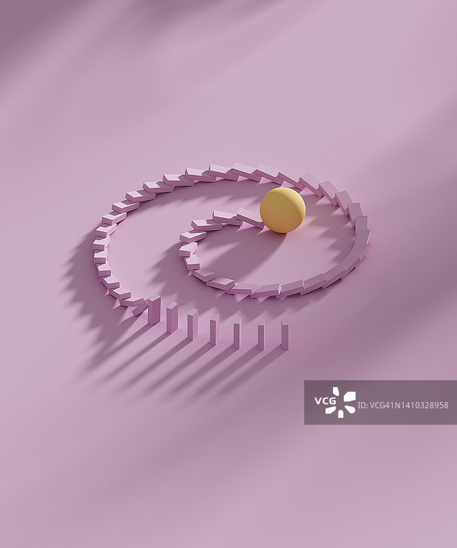 黄色球体击倒螺旋排列多米诺骨牌的摄影棚拍摄图片素材