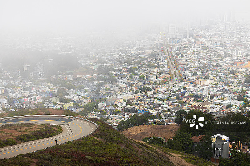 日出时分，年轻男人在旧金山的山上跑步图片素材