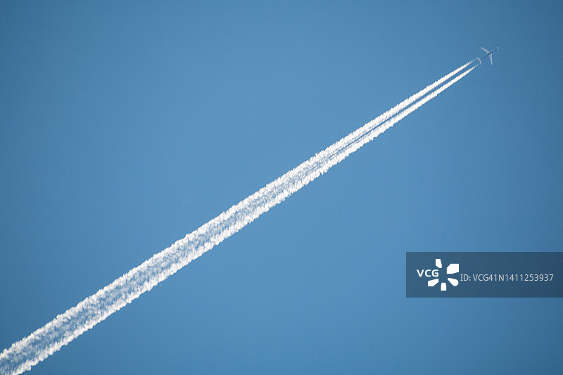 天空中留下水汽痕迹的飞机图片素材