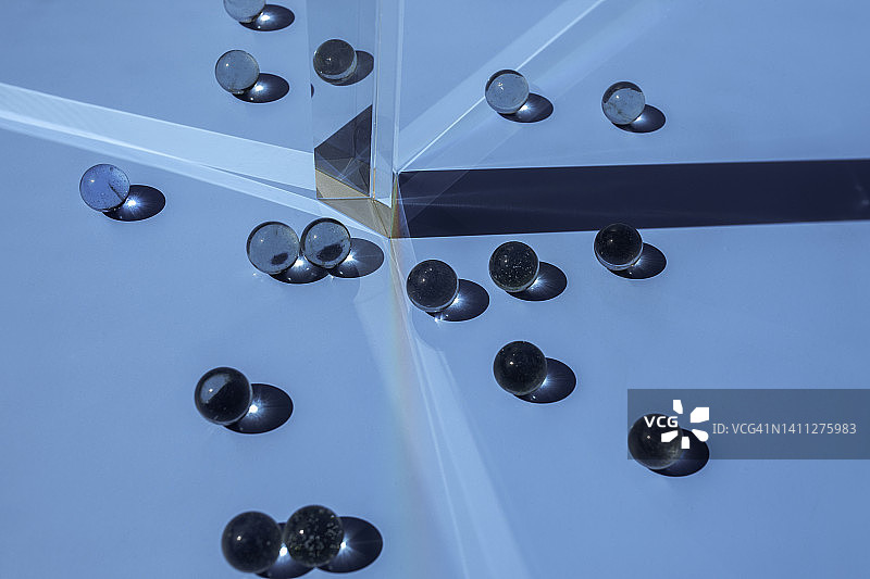 蓝色背景上的玻璃棱镜和玻璃球图片素材