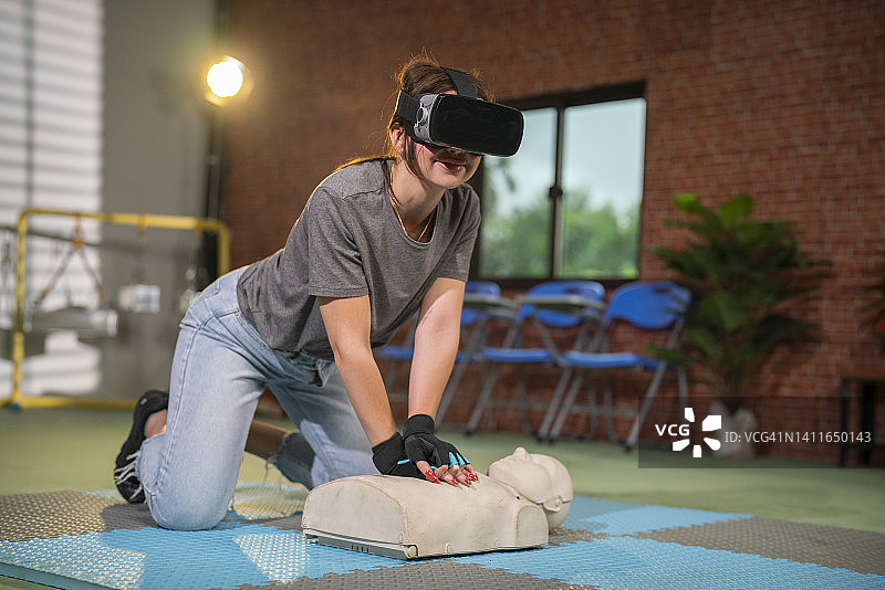 戴眼镜的女人正在进行VR心肺复苏教育培训图片素材