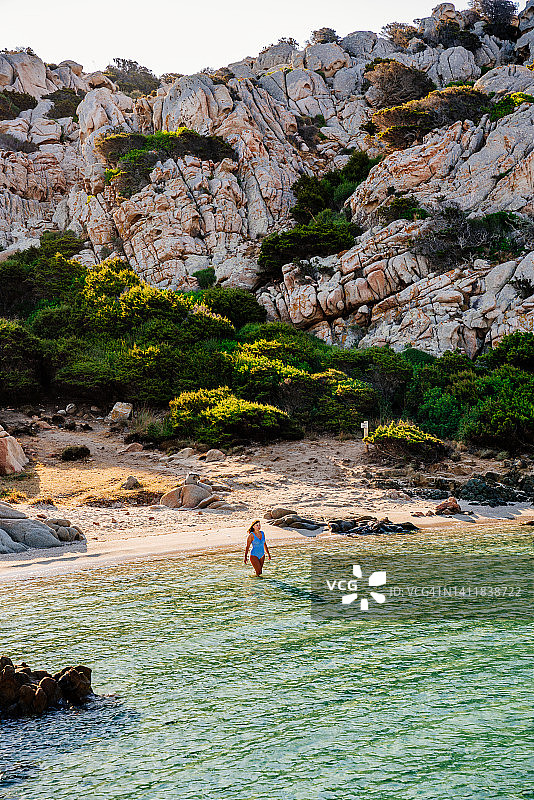 女人在意大利撒丁岛卡普雷拉岛的卡拉那波勒塔纳海湾沐浴图片素材