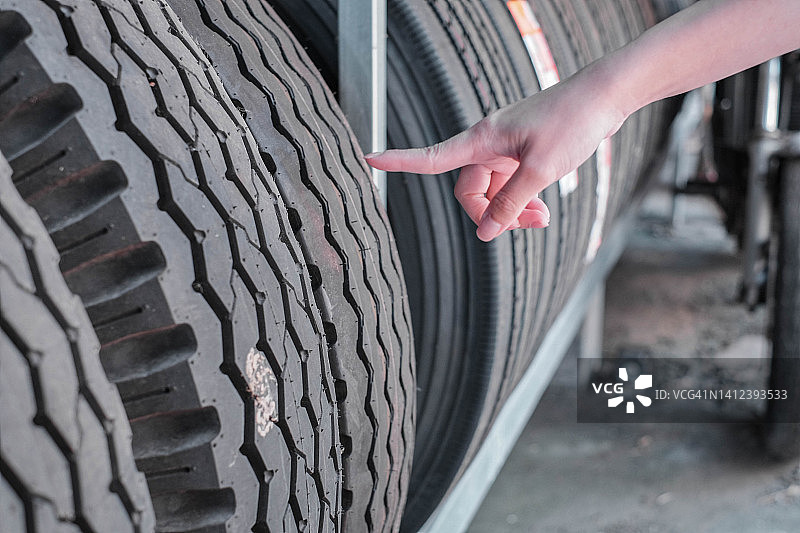 用食指指向汽车轮胎的人图片素材