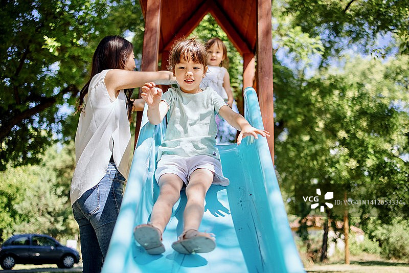 小女孩快乐地玩滑梯图片素材
