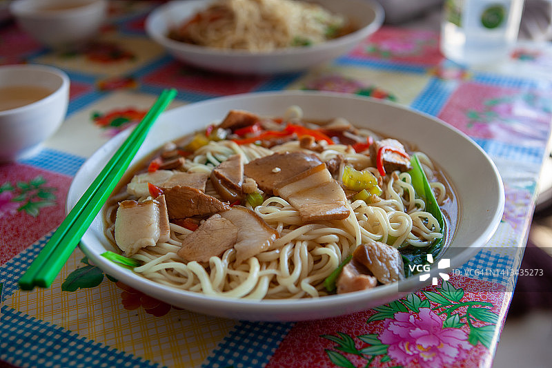 佐以酱汁、猪肉片和蔬菜的面条图片素材