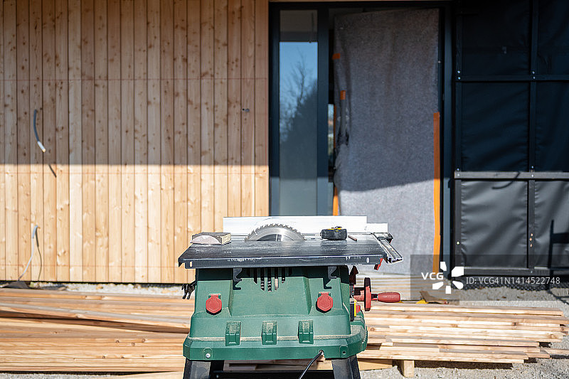 室外木板堆上的电动圆锯图片素材