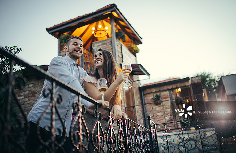 年轻情侣享受浪漫夜晚品尝红酒图片素材