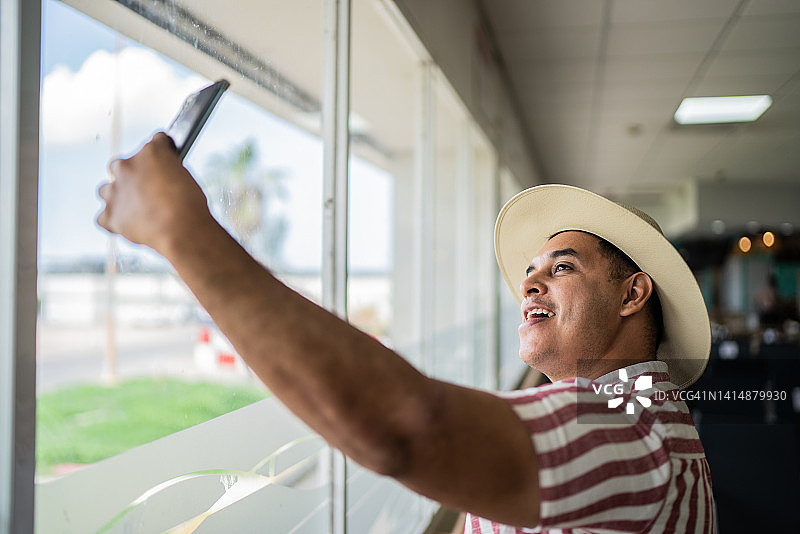 中年男人在机场用手机自拍图片素材