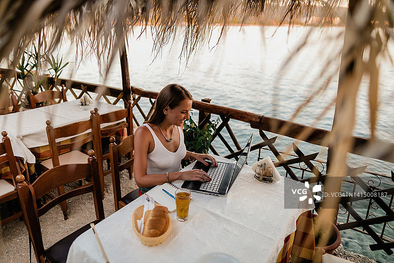 女子在海滨度假时学习和做作业图片素材