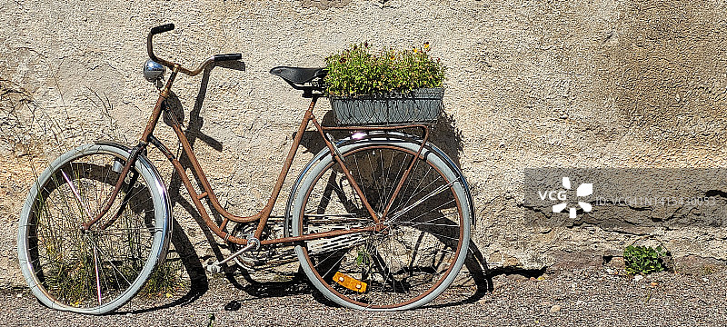 房屋石膏墙旁的生锈自行车图片素材