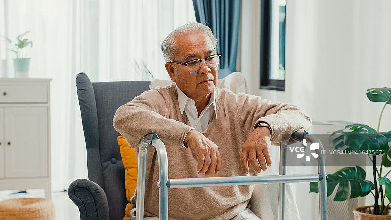 孤独的亚洲老人坐在轮椅上，渴望家人朋友图片素材