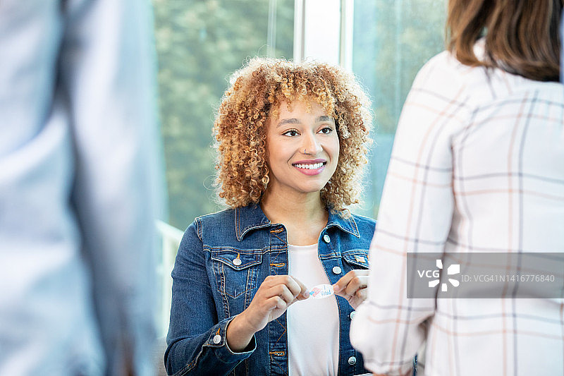 青年志愿者向当地选民分发投票贴纸图片素材
