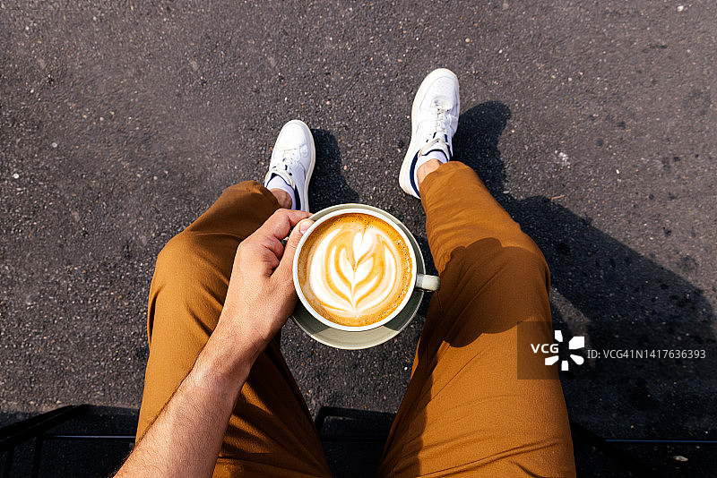 户外，男人喝拿铁的个人视角图片素材