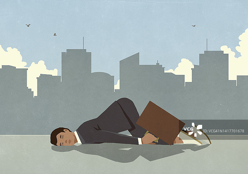 疲惫的商人在城市人行道上睡觉图片素材