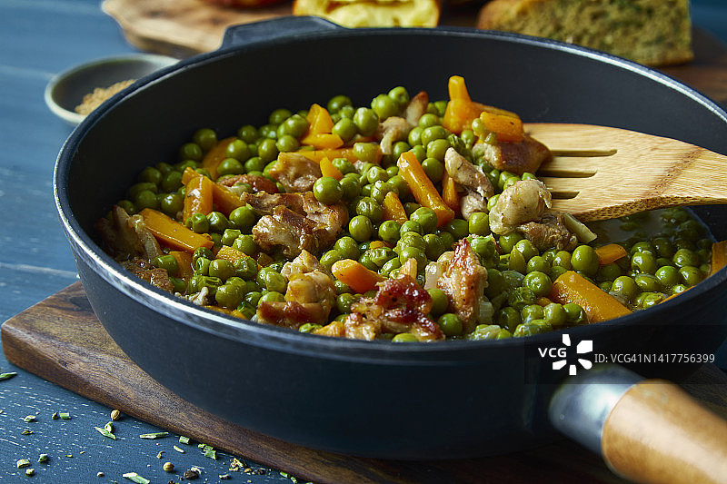 平底锅里的胡萝卜鸡肉炒青豆图片素材