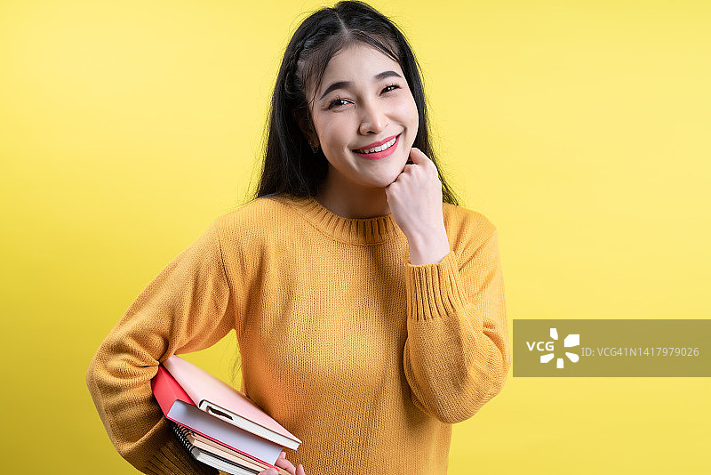 微笑的女学生、教师或女商人拿着书的独立工作室肖像图片素材