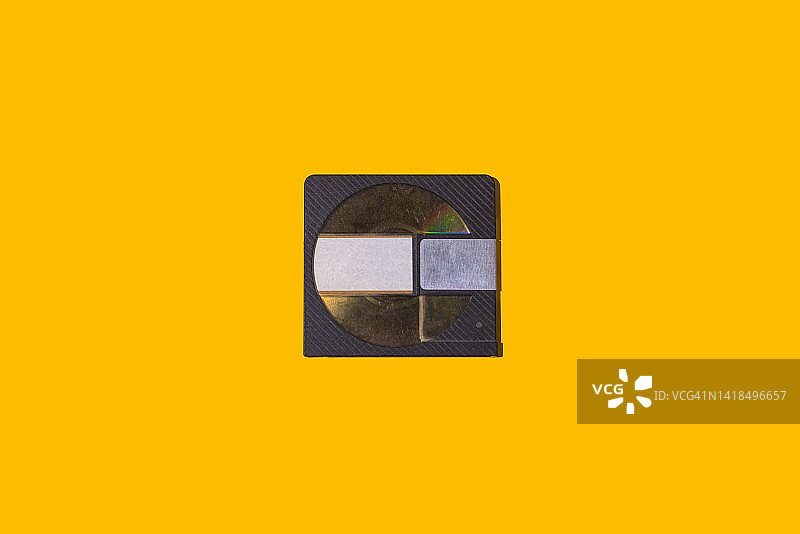 黄色背景上的黑色迷你光盘图片素材