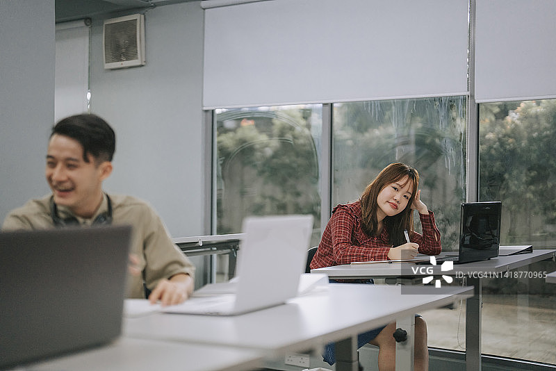 课堂上看着镜头的无聊女学生图片素材