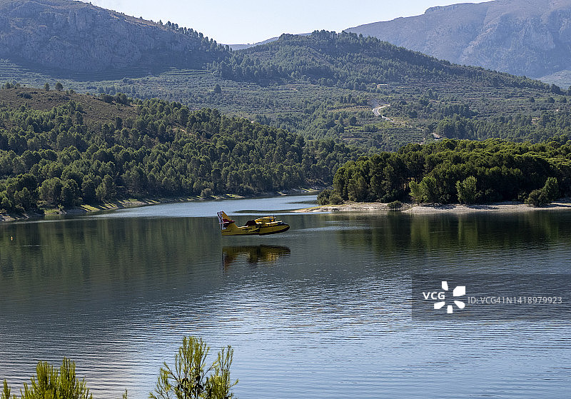 CL-215水陆两栖飞机在水库降落，装载水源扑灭森林火灾图片素材