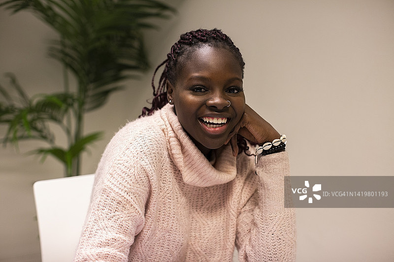 快乐的穿着毛衣的学生坐在教室里图片素材