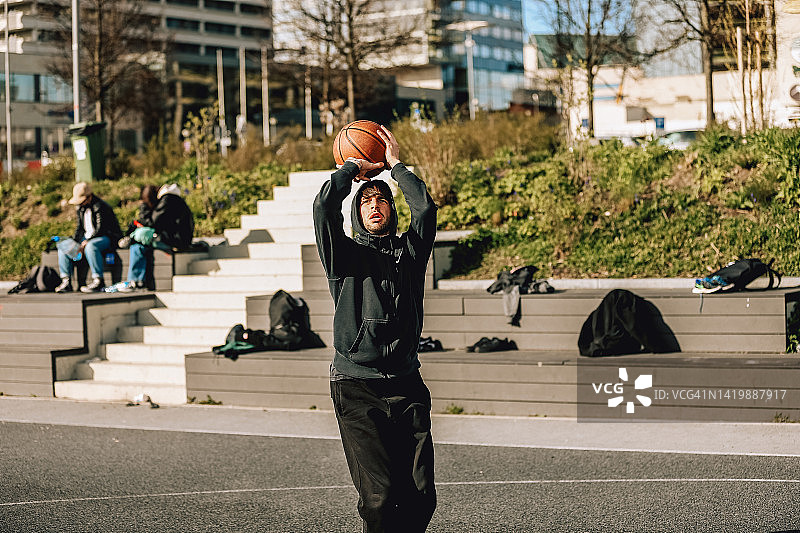 人们在街头打街球，篮球运动摄影，城市生活概念，人们用球进行比赛图片素材