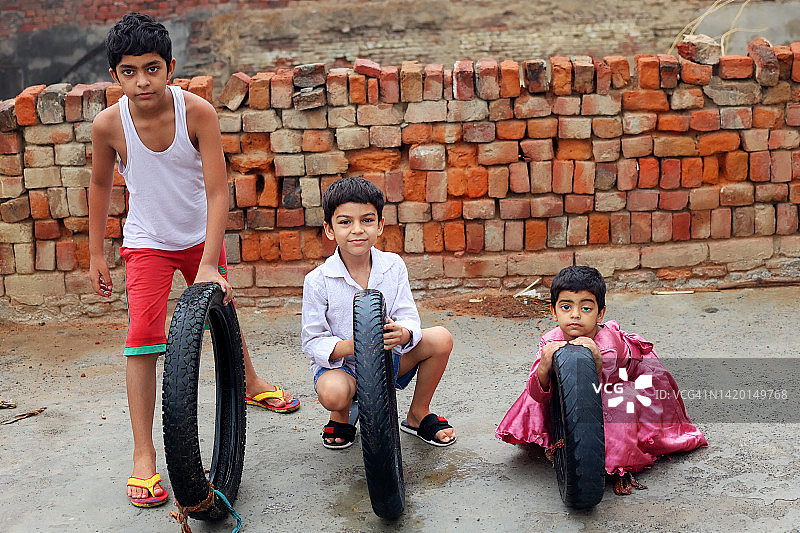 在家玩轮胎的贫困儿童图片素材