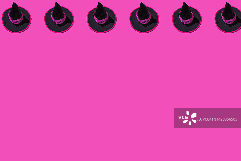 粉色背景上的黑色万圣节女巫帽图案图片素材