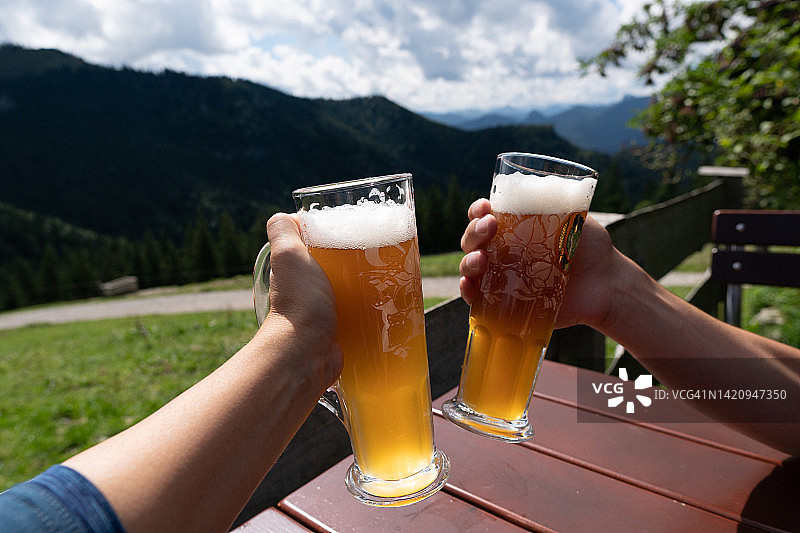 阿尔卑斯牧场木桌上的啤酒杯图片素材